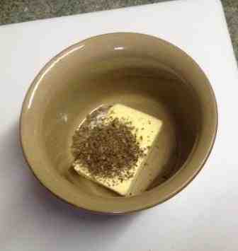 basil sprinkled on top of butter in a dish basil sprinkled on top of butter in a dish