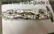 Wrapping garlic bread in aluminium foil for baking Wrapping garlic bread in aluminium foil for baking
