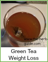 green tea infusing in a glass cup