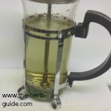 pushing the plunger on the cafetière to make the mint tea pushing the plunger on the cafetière to make the mint tea